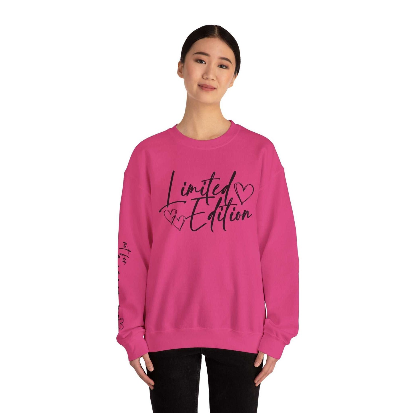 Woman wearing pink Limited Edition Script Hearts Sweatshirt with black script and heart design on chest and sleeve