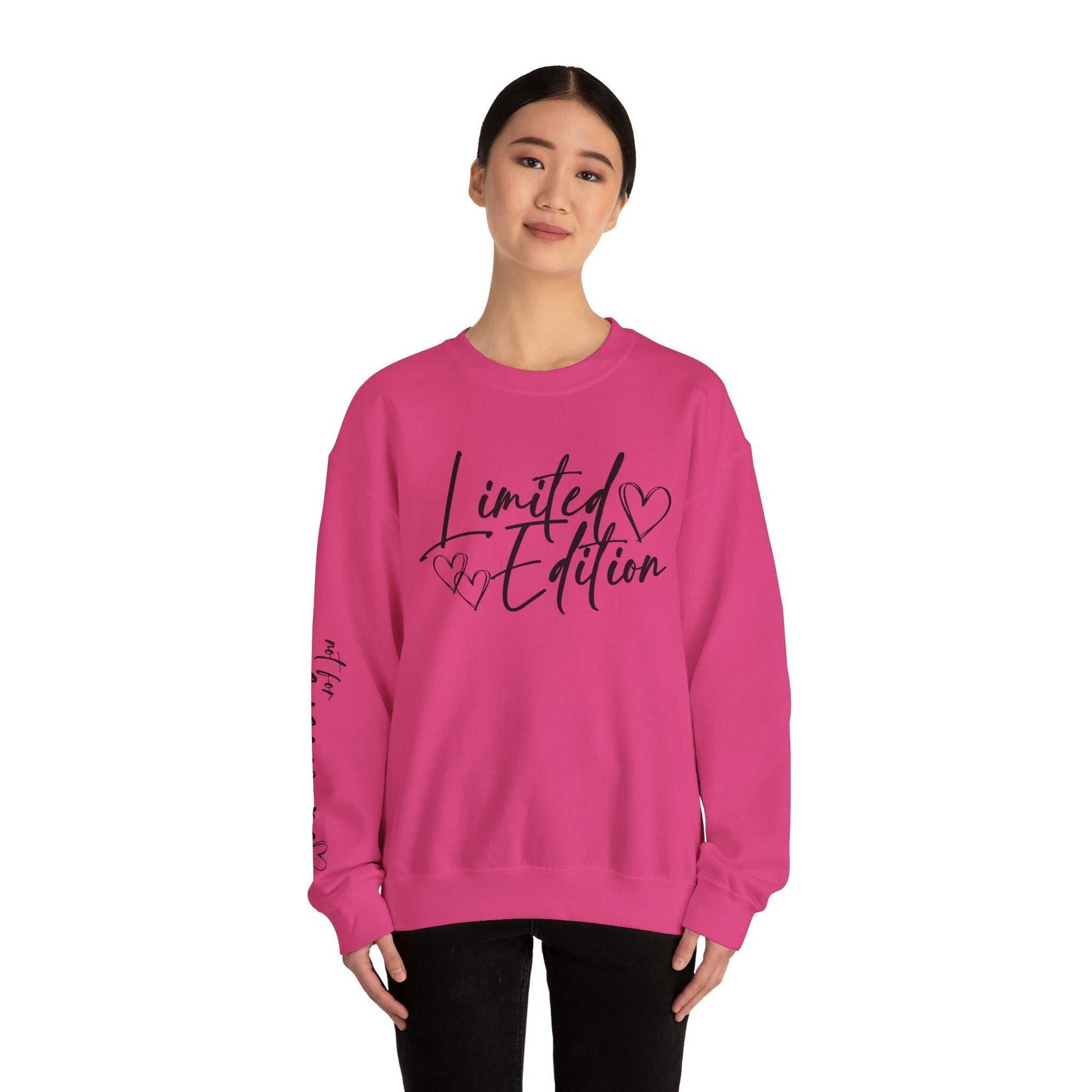 Woman wearing pink Limited Edition Script Hearts Sweatshirt with black script and heart design on chest and sleeve