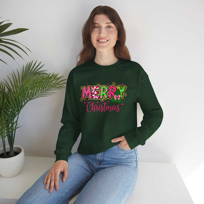 Woman wearing green Merry Christmas Candy Cane typography sweatshirt sitting indoors