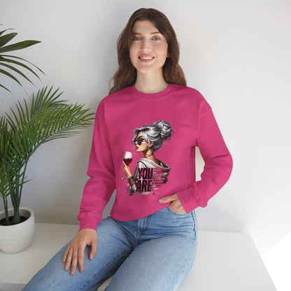 Woman wearing pink Chic Woman with Wine Sweatshirt featuring silver-haired woman graphic holding wine glass