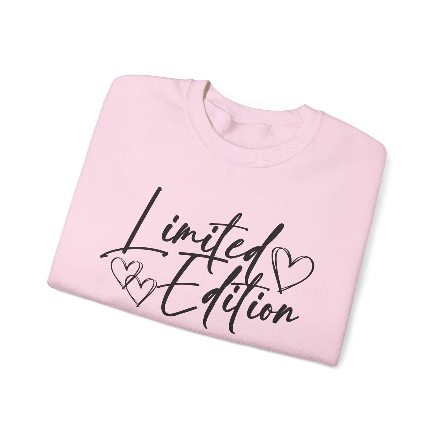 Folded white crewneck sweatshirt with black "Limited Edition" script and hand-drawn hearts design on chest and sleeve, cozy and relaxed fit