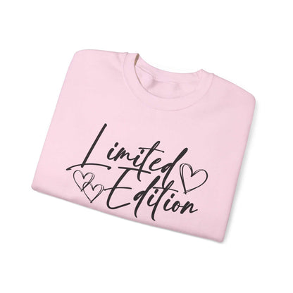 Folded white crewneck sweatshirt with black "Limited Edition" script and hand-drawn hearts design on chest and sleeve, cozy and relaxed fit