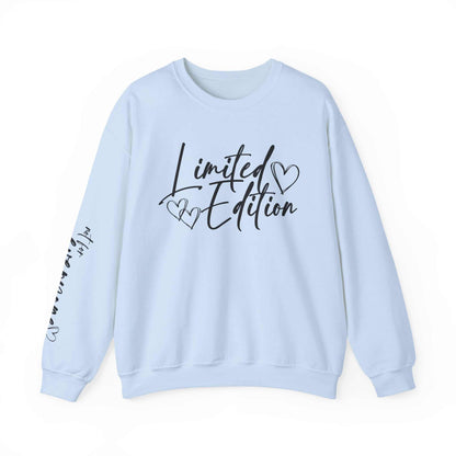 White crewneck sweatshirt with black "Limited Edition" script and hand-drawn hearts on chest and sleeve