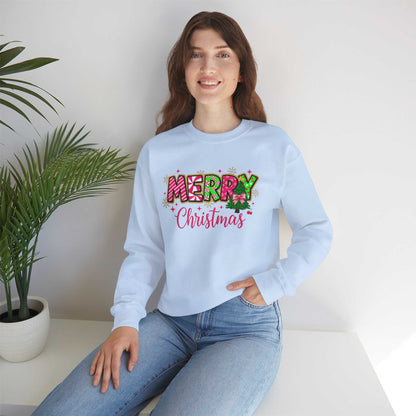 woman wearing light blue Merry Christmas Candy Cane typography sweatshirt sitting indoors
