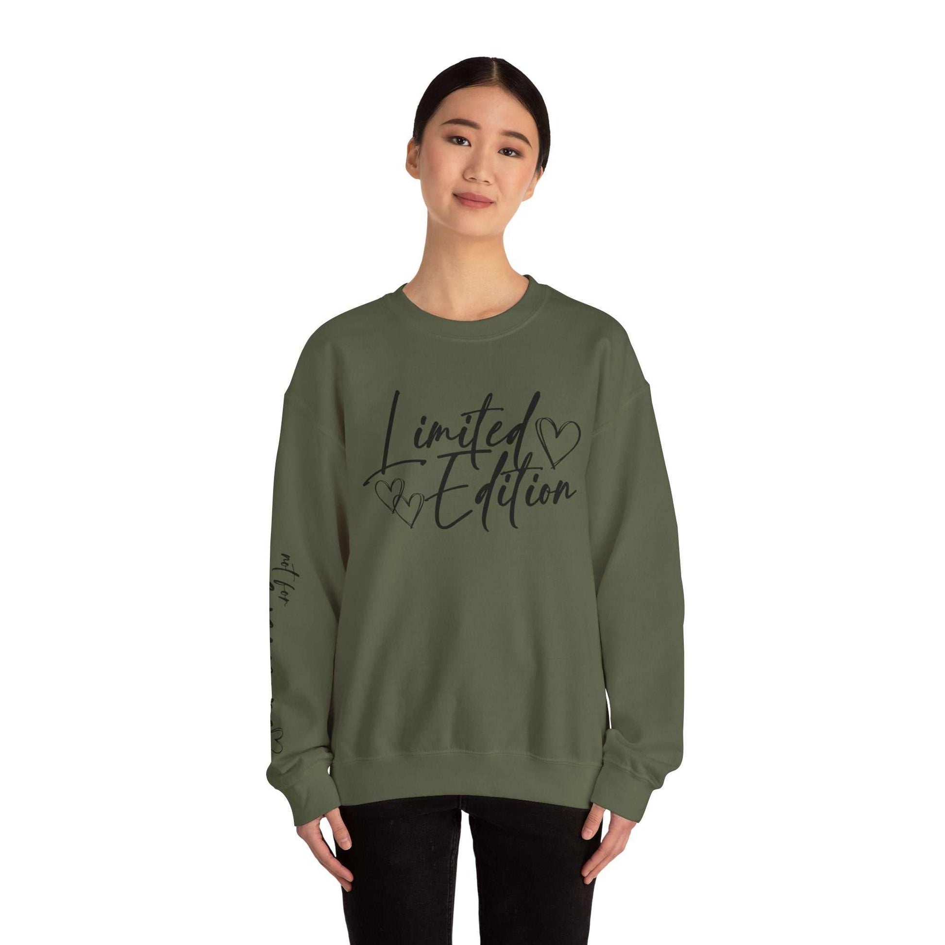 Woman wearing olive green Limited Edition Script Hearts Sweatshirt with black script and heart designs on chest and sleeve