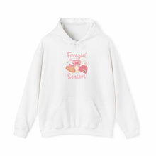 White cozy hoodie with winter boots, hat, mittens graphic and "Freezin' Season" text