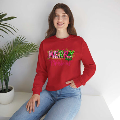Woman wearing red Merry Christmas Candy Cane typography sweatshirt sitting by white table with green plant