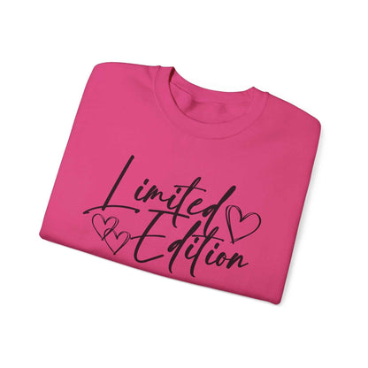 Folded pink Limited Edition Script Hearts Sweatshirt with black script and heart design