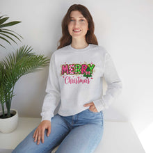 woman wearing gray Merry Christmas Candy Cane typography sweatshirt sitting indoors near potted plant