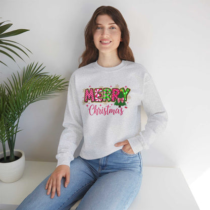 woman wearing gray Merry Christmas Candy Cane typography sweatshirt sitting indoors near potted plant