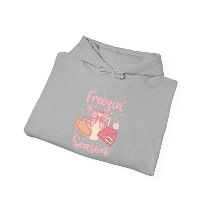 Gray hoodie with winter boots hat mittens graphic and "Freezin' Season" text in pink