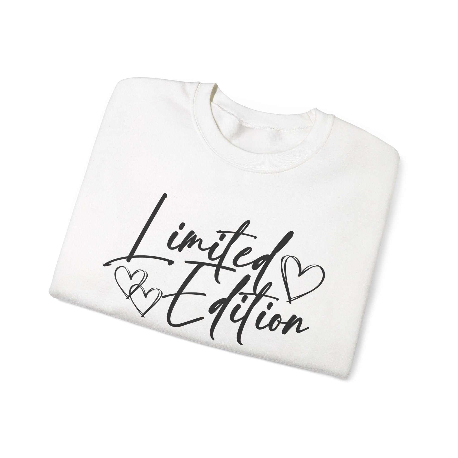 White crewneck sweatshirt with black "Limited Edition" script and hearts design, cozy and relaxed fit Limited Edition Script Hearts Sweatshirt.