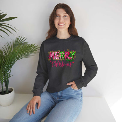 woman wearing black Merry Christmas Candy Cane typography sweatshirt sitting indoors with palm plant in background
