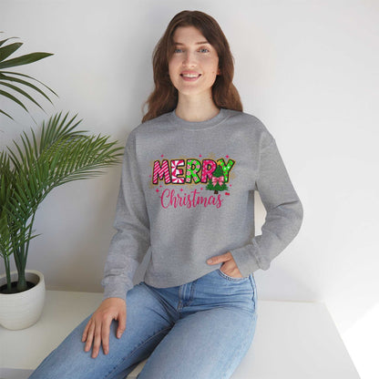 woman wearing gray Merry Christmas Candy Cane typography sweatshirt sitting indoors with plant
