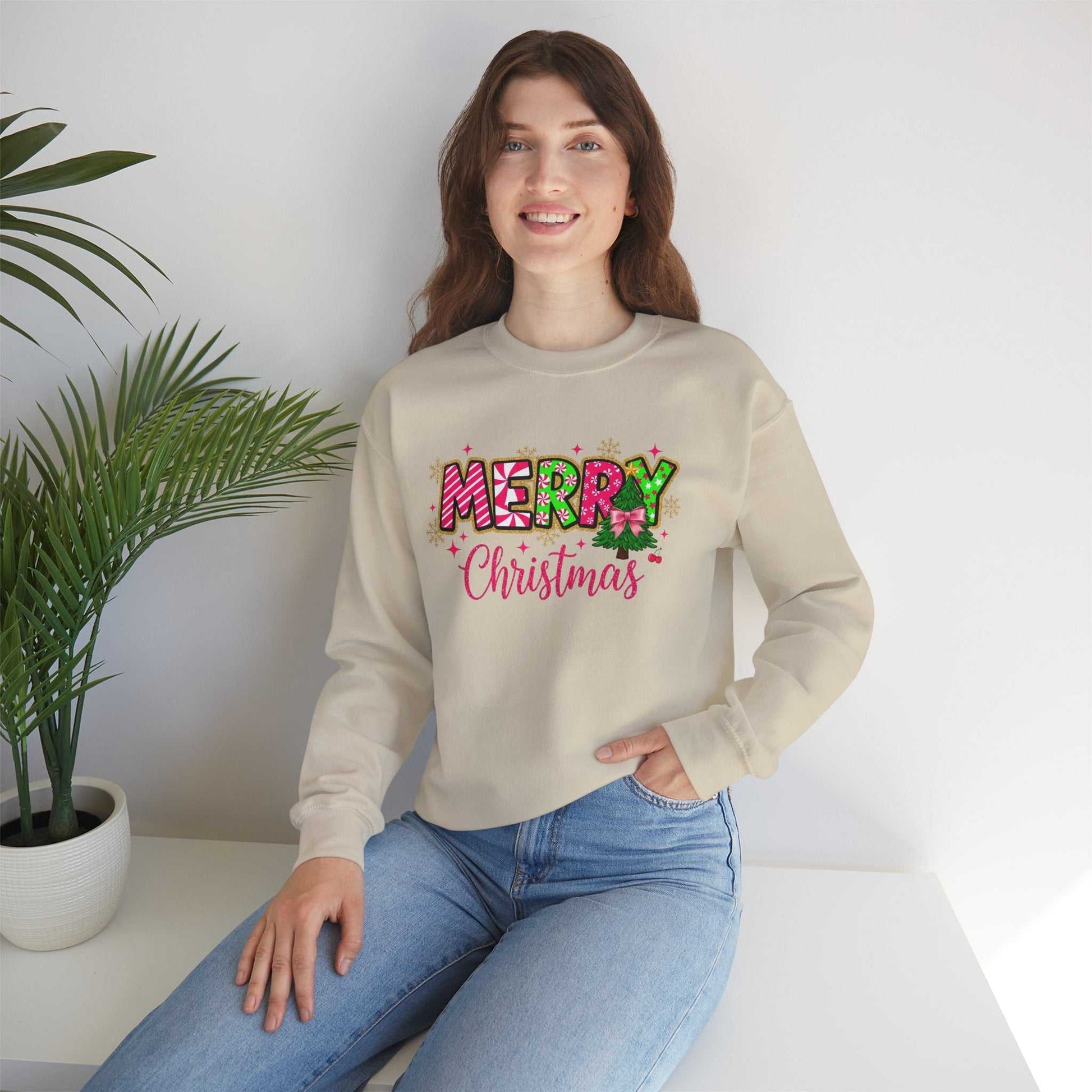 woman wearing Merry Christmas Candy Cane typography sweatshirt sitting indoors near plant