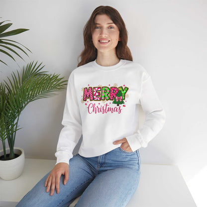 Woman wearing white crewneck sweatshirt with colorful Merry Christmas Candy Cane typography design sitting indoors
